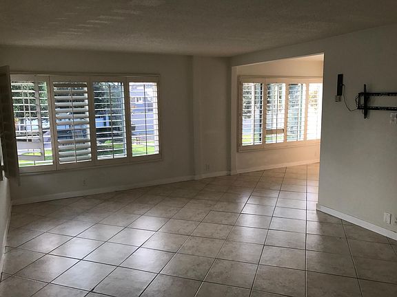 Large and open combined living room, dining and kitchen area with park and bay views.