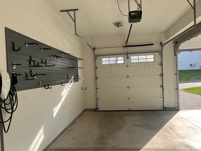 Garage with wall storage and tesla charger