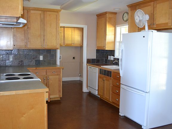 Kitchen includes refrigerator, dishwasher, range, and hookup