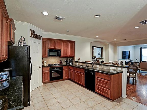 The kitchen features lots of cabinet space and a large pantry