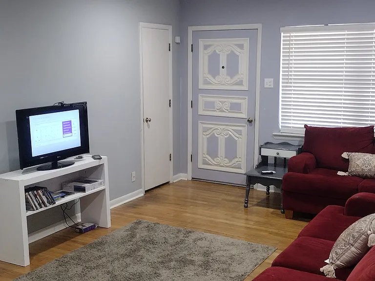 32 inch TV with Ruko free movie. wood shades and center carpet.