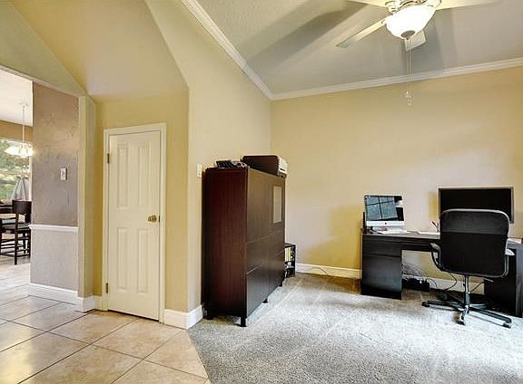 The interior features tall ceilings, crown molding and custom paint selections.