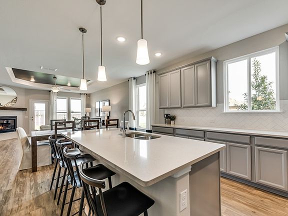 View of dining and gathering room from kitchen island model representation