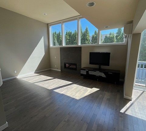 Open light bright Living Room with plenty of hardwood flooring.