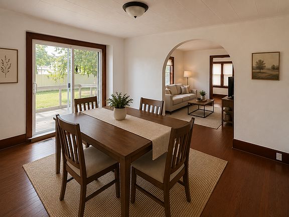 Dining room with walk out slider to partially fenced in backyard