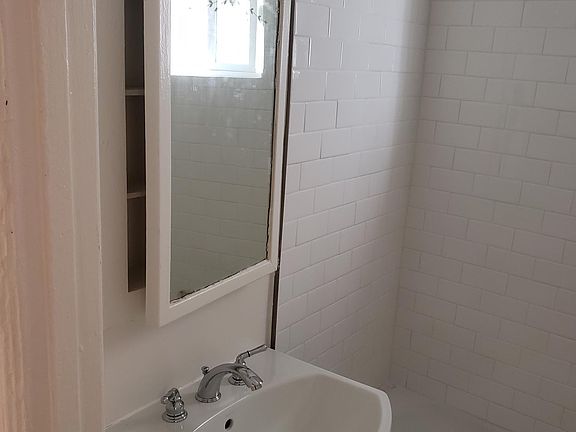 Bathroom with pedestal sink and newly remodeled tile.