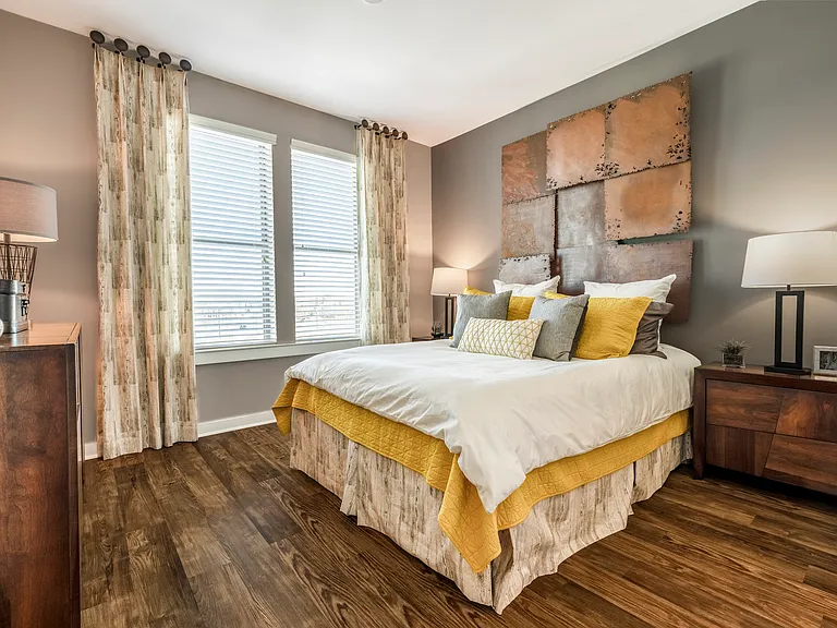 Bedroom with wood-designed flooring and window