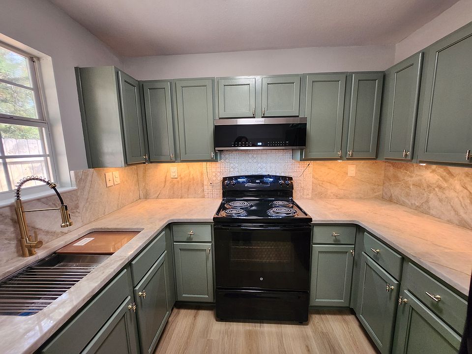 TAJ MAHAL QUARTZ COUNTERTOPS, WORKSTATION SINK WITH DRAINER, COLANDER AND CUTTING BOARD, UNDERCOUNTER LIGHTS, LED CEILING LIGHTS AND LVP WATERPROOF FLOORING!NEW LOW PROFILE MICROWAVE