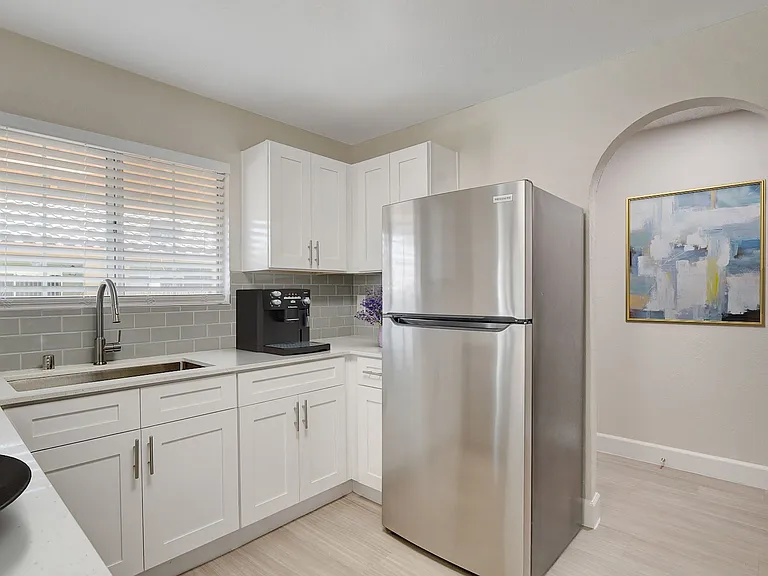 Step into the inviting kitchen of Invitational, where modern appliances meet stylish design. Enjoy ample counter space and a sleek stainless steel fridge, perfect for culinary adventures. Schedule your tour today to see it for yourself!