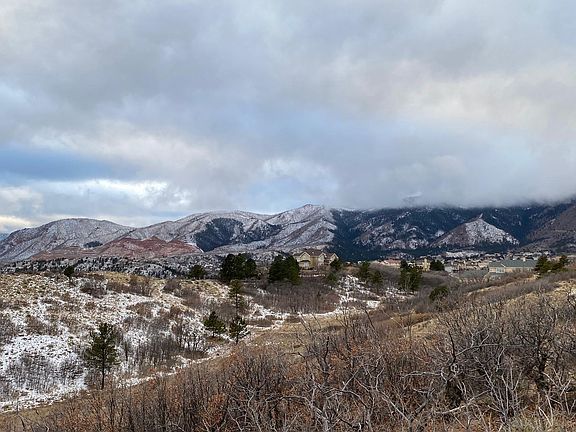 The home nestled into natural land on the right. The only neighbor is a distance to the left.