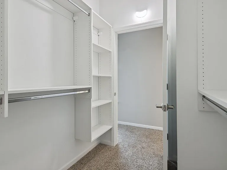 Walk-in closet with built-in shelves and rods