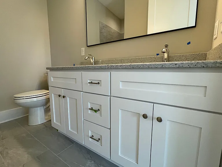 Owners Suite Bath with Double Sinks and Granite Countertops, Designer Lighting an Mirror