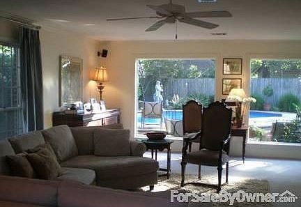 Beautiful views of pool from over-sized windows in den.