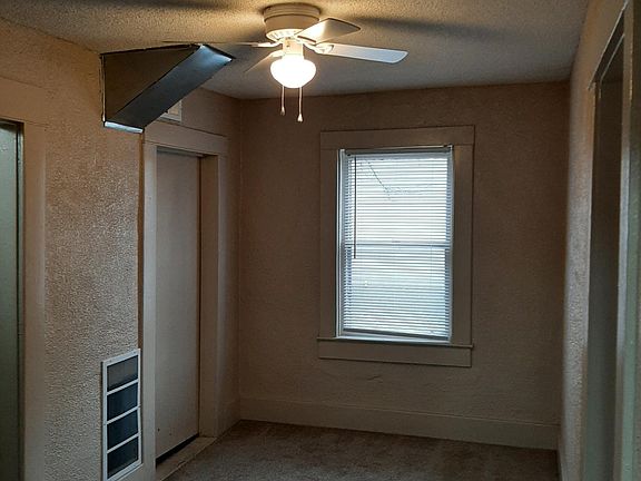 smaller bedroom facing to south; larger bedroom is to right in picture; bathroom and utility room are to left in picture