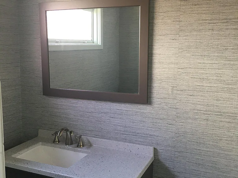 Second bathroom updated one year ago and newly hung sea grass wallpaper.