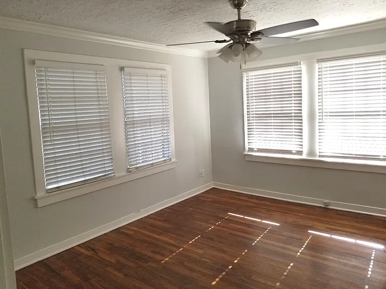Bedroom has lots of windows.