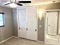 Bedroom Louvered closet doors, tile floors throughout