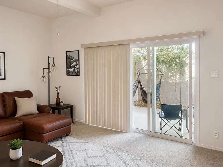 Private patio access with bright natural light and vaulted ceilings.