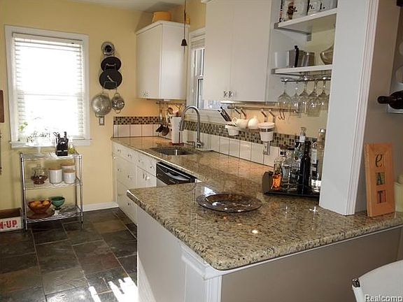 Updated kitchen with granite counters and slate floor