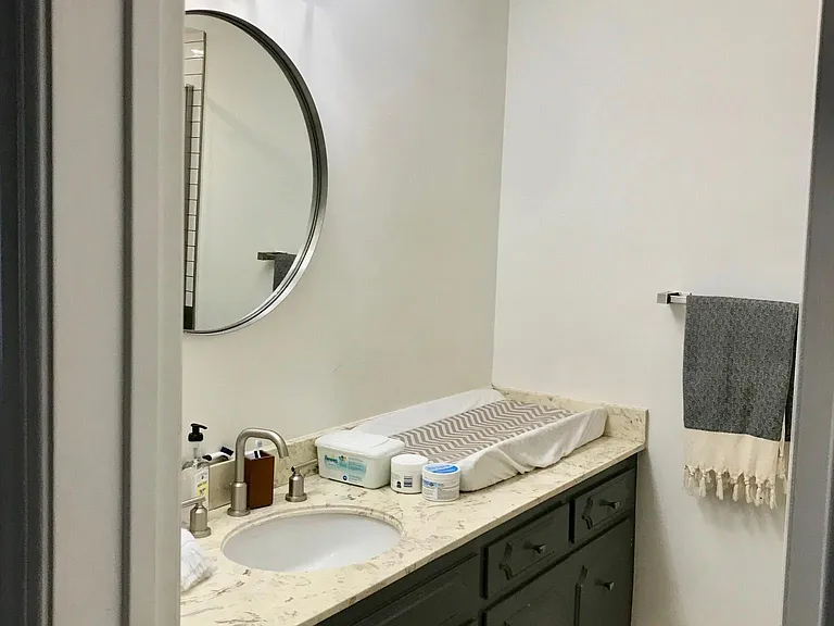Guest bath; travertine floors, original counters and vanity