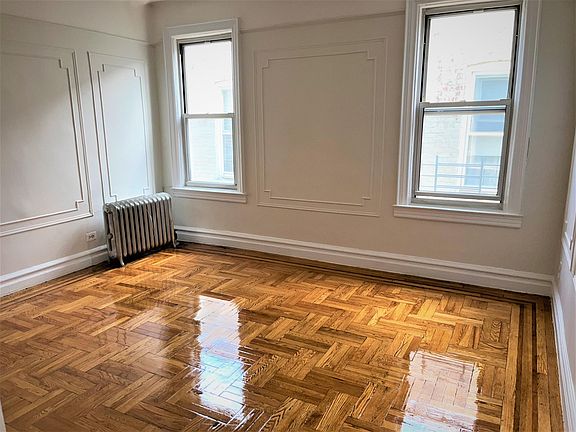 Large Living room with refinished original 1920s parquet hardwood floors and plaster wall moldings