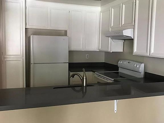 Kitchen with gorgeous stone countertop.