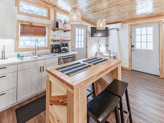 Our open kitchen features a welcoming bar, perfect for morning coffee or late-night appetizers and cocktails. Ideal for casual gatherings.