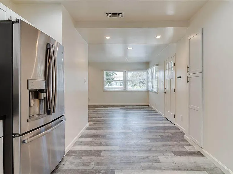 Beautifully updated kitchen with white shaker cabinetry, granite counters, brushed nickel pulls and handels, stainless appliances and more