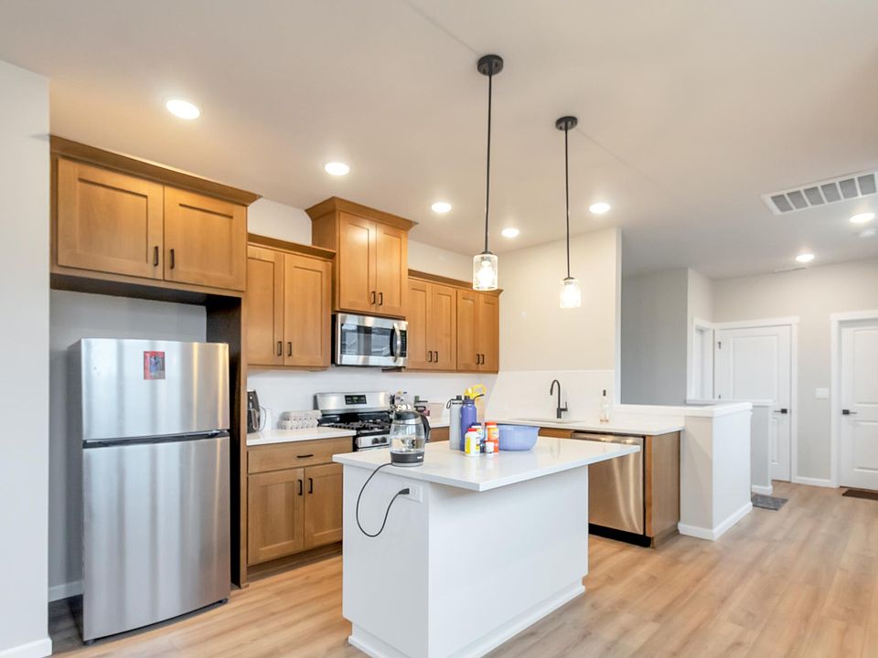 Kitchen with Steel appliances and quartz counter tops. Fridge included.