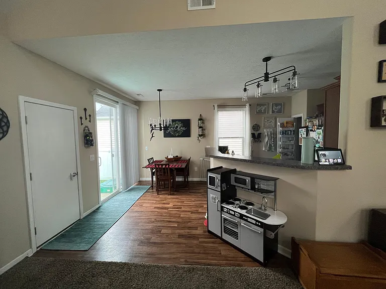 kitchen, dining area with sliding door access to backyard, door access to garage