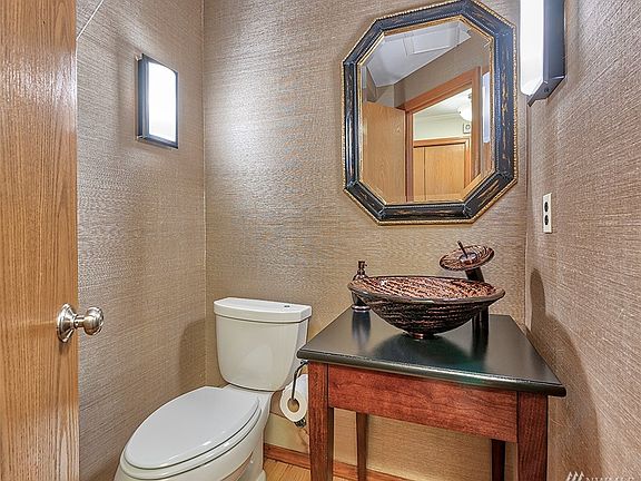This powder room is discretely located in the hall between the foyer and family room.