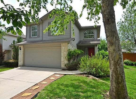 Large trees shade the front yard and welcome you home every day.
