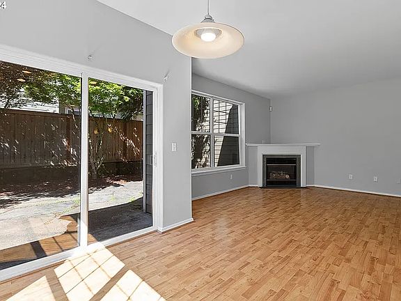 Living room, dining area, and easy access to peaceful backyard