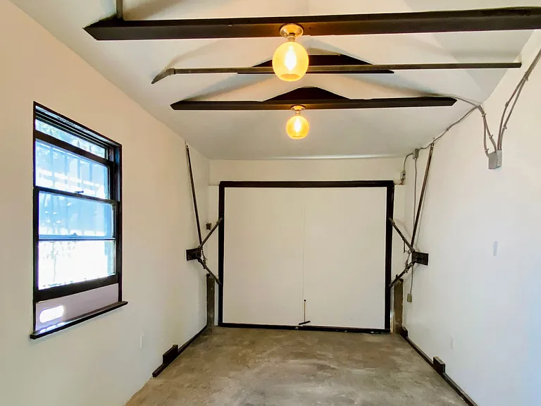 Attached garage with flexible studio, office, or art space.