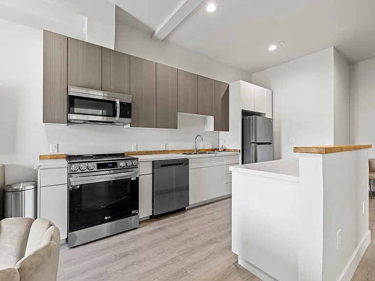 Spacious and bright kitchen area, perfect for cooking up delicious meals and creating lasting memories with loved ones. Plenty of room for culinary creativity to flourish!.