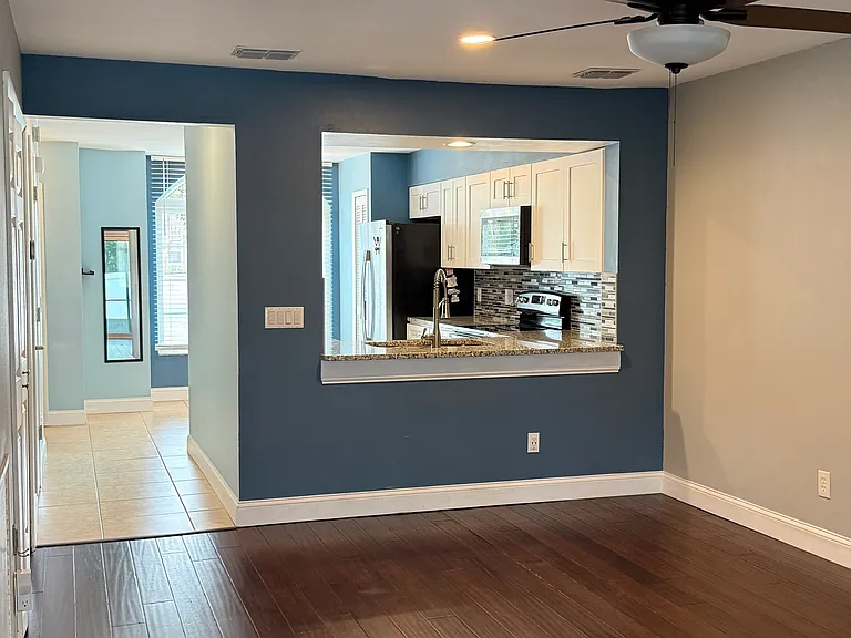 View from the living room towards the front and kitchen view.