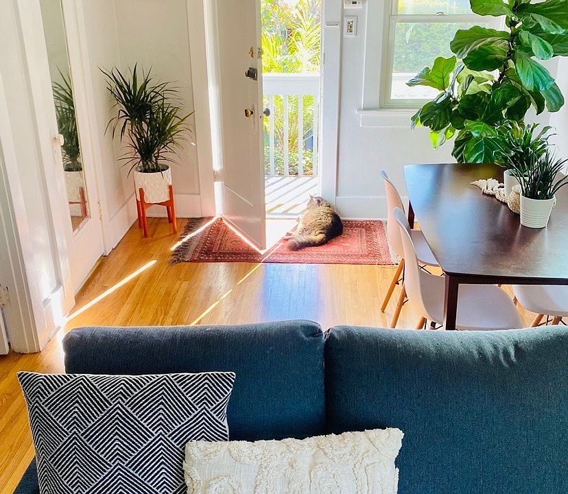 Living room facing out to private patio off front door. Very light and bright. All photos are showing prior tenant's belongings and can be used as a guide for what can fit, and for design ideas as she is a designer. The unit is unfurnished.