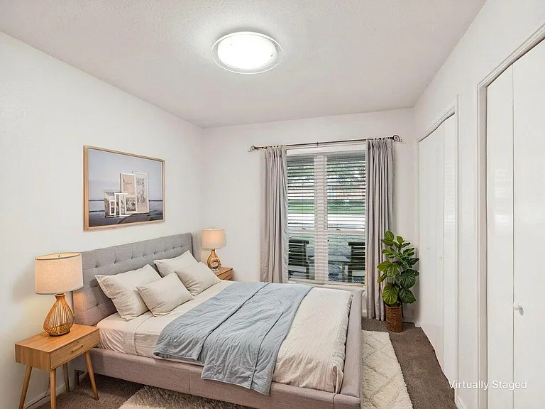 Bedroom 4 - offers new paint and carpet with two separate closets and a large window that faces out to the front yard.