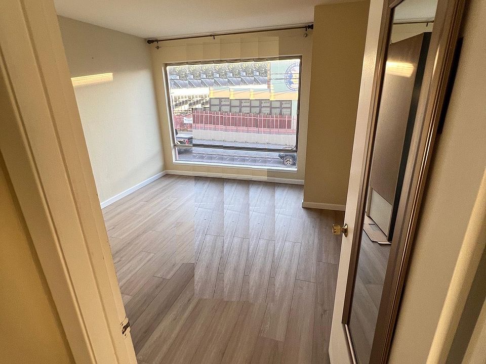 Main bedroom facing street, with new laminate wood floors.