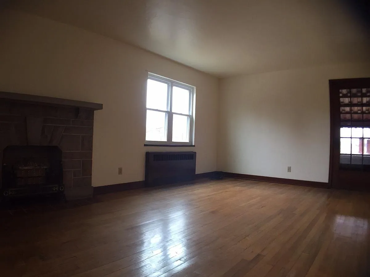 Large living room with hardwood floors and updated windows - 1866 Perrott St #2