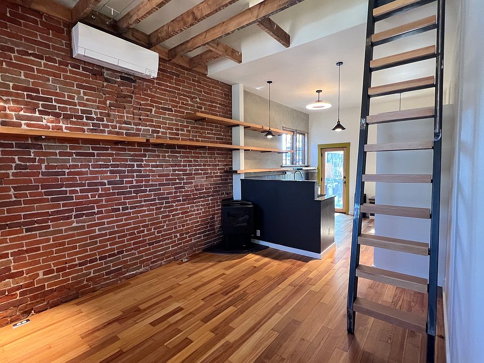 Floors have been newly refinished; ductless heating/cooling unit is brand new, and the ladder is to access the upstairs lofted bedroom.