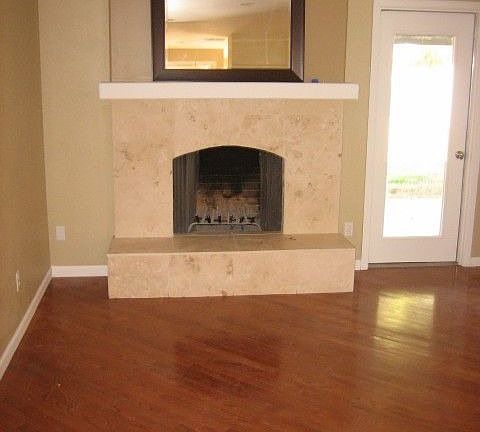 hardwood flooring and travertine fireplace