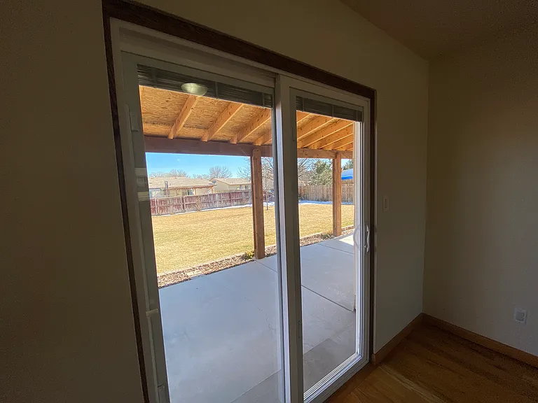 Large backyard with mature trees and plenty of outdoor space to relax, play, garden, or enjoy Colorado evenings_with lawn maintenance included.