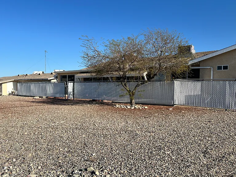 There is additional land beyond the fence that is part of the .28 acre land parcel that the home sits on