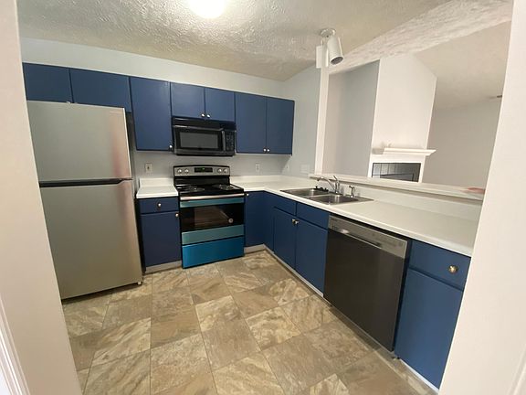 Kitchen (Stainless Steel fridge and range. Black microwave and dishwasher)