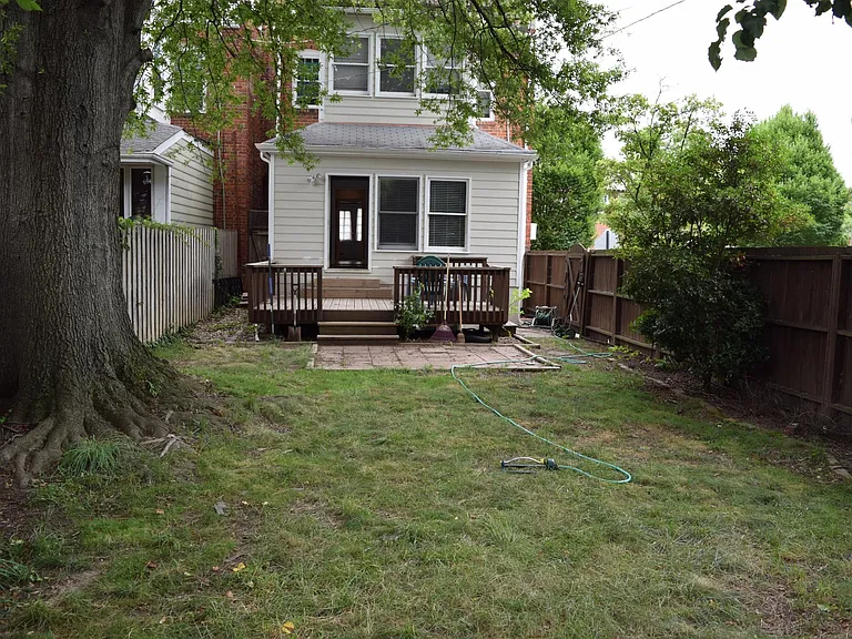 Large private back yard with two gates and 6' tall privacy fence, deck and patio.