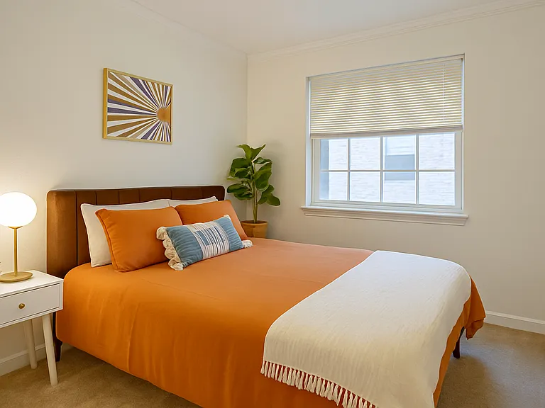 Cozy and colorful bedroom with a comfy queen bed, warm earthy tones, and soft natural light_perfect for a peaceful night's rest.