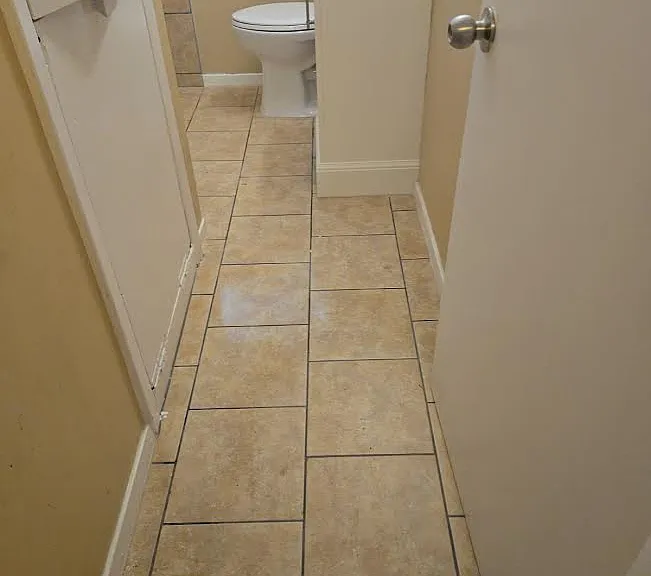 Bathroom features convenient built in laundry hamper.