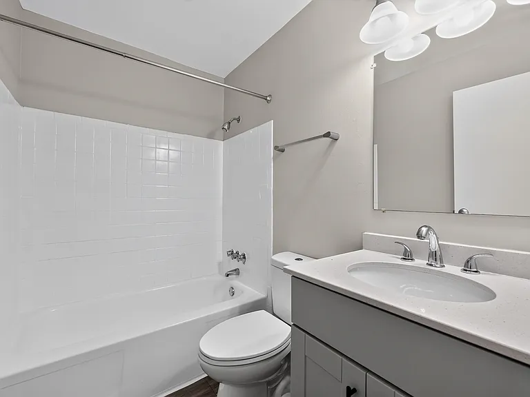 Enjoy a clean, modern bathroom featuring crisp white fixtures at Renaissance at Carol Stream in Carol Stream, IL.