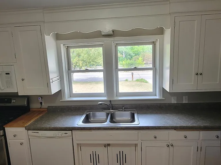 full wall of cabinets to ensure you have plenty of space. Newer appliances for your convenience.
